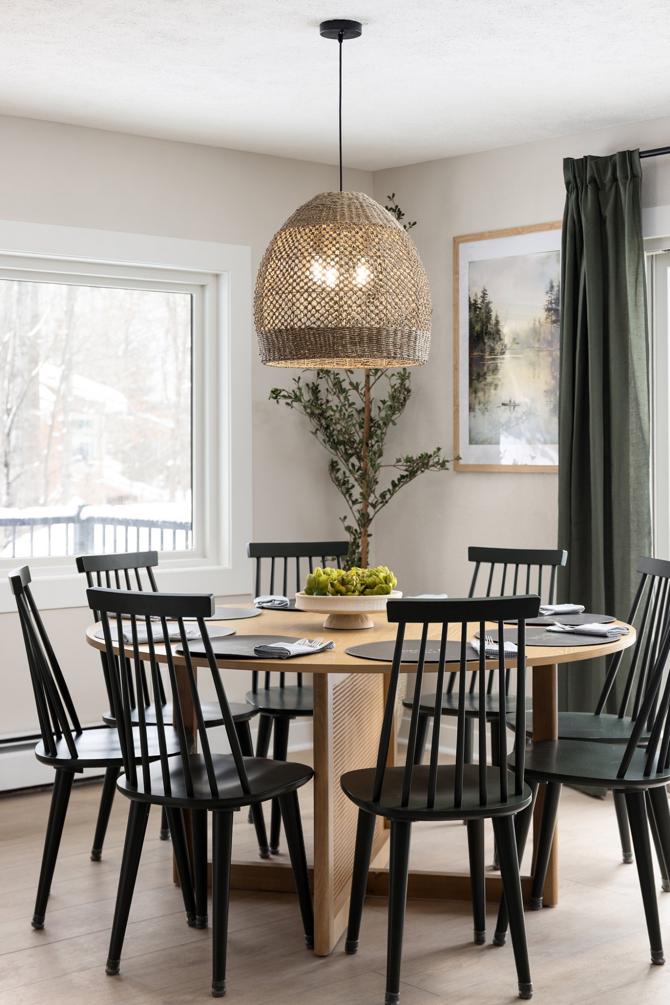 Round dining table with wicker pendant