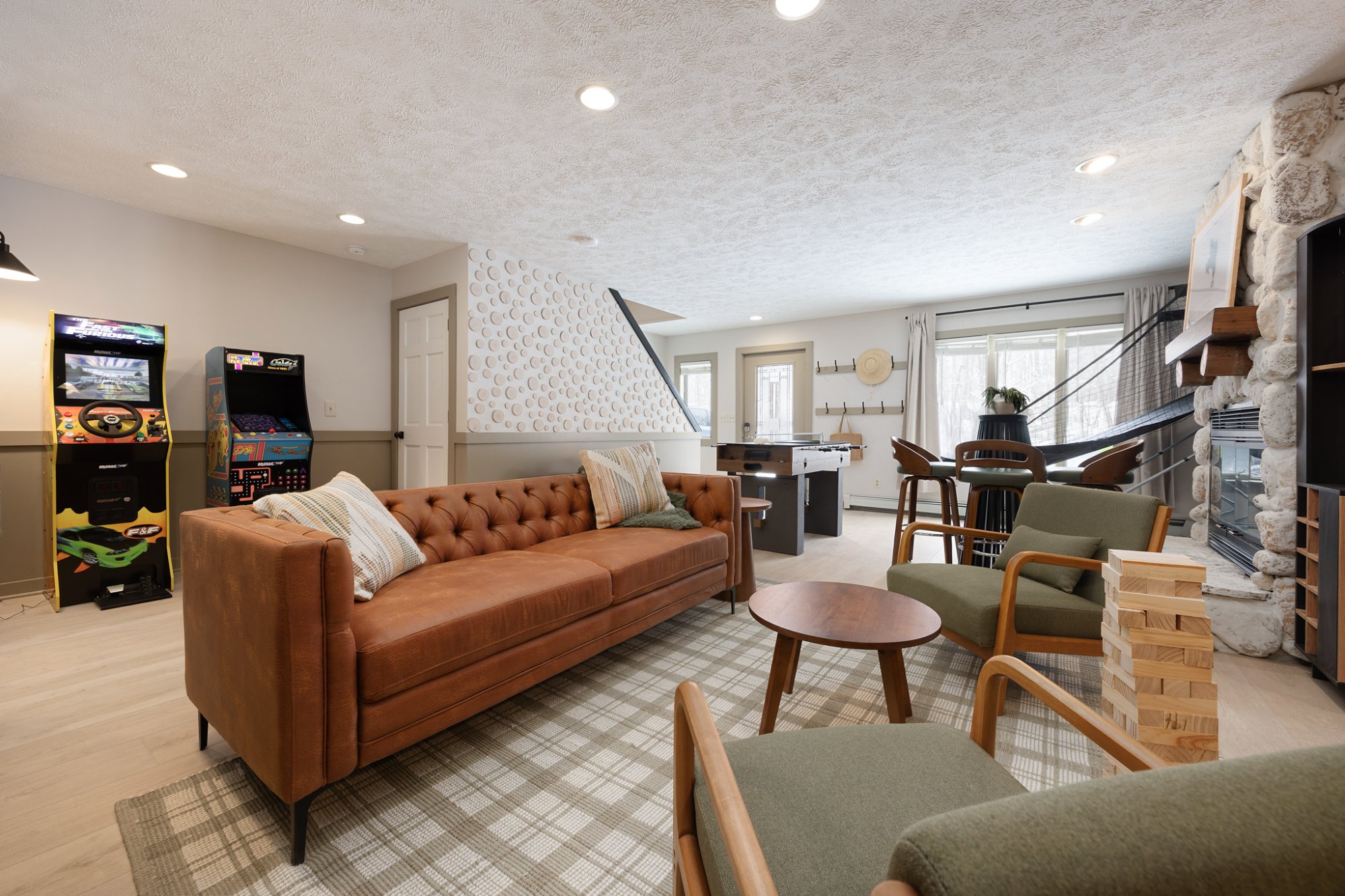 Game room with leather sofa and arcade