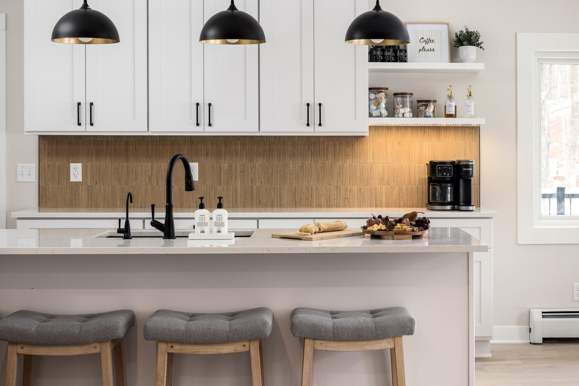 Birch + Still kitchen with pendant lights and wood backsplash